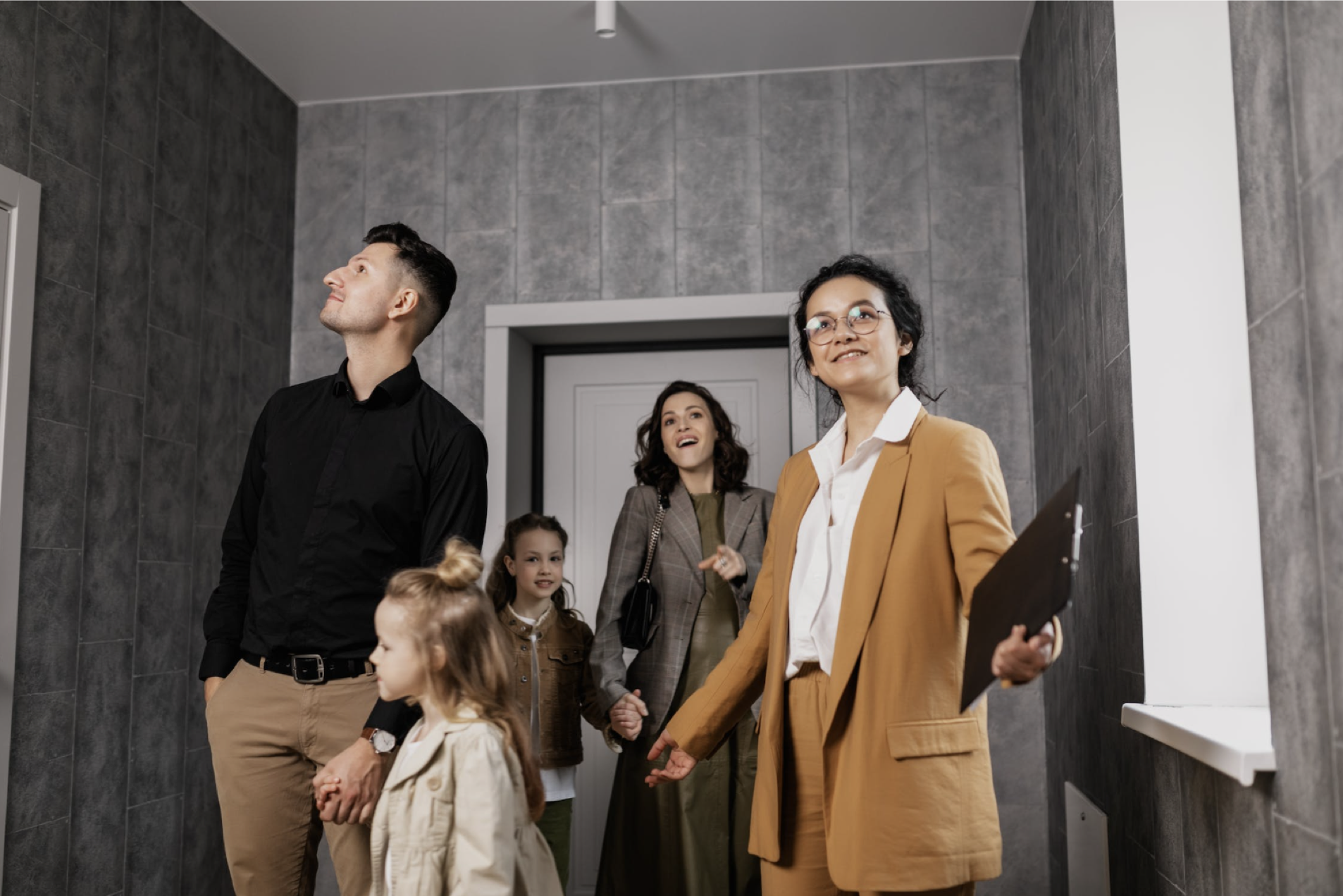 property managers showing tenants and their kids around a property